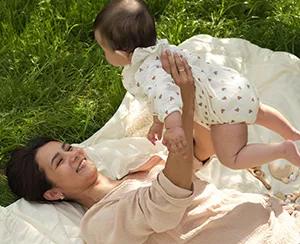 New mom holding baby, focusing on postpartum mental health and self-care strategies