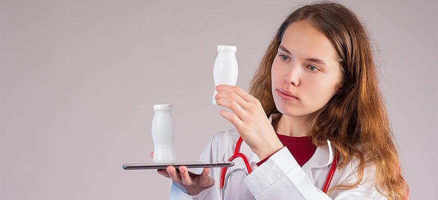 probiotics for diarrhea — doctor examining probiotic supplement bottles