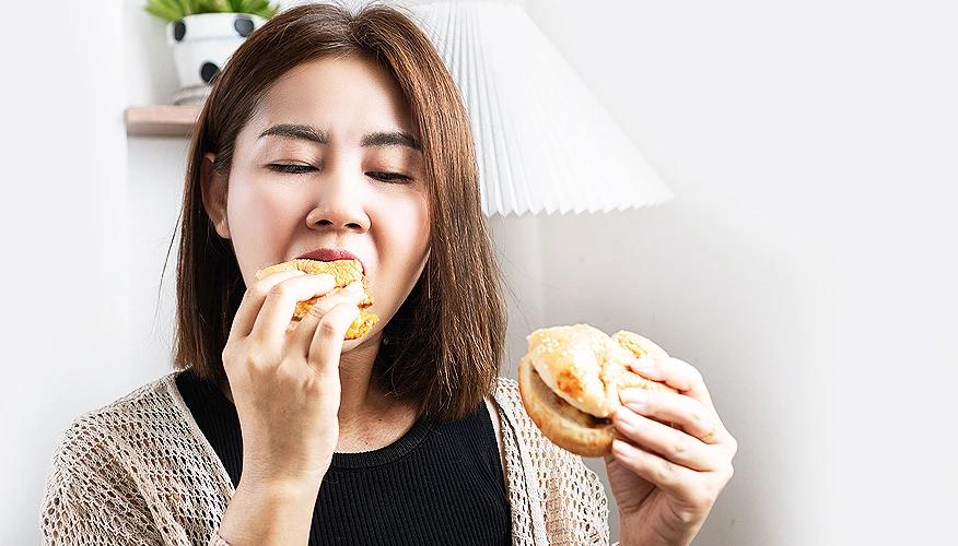 Woman eating ultra processed food