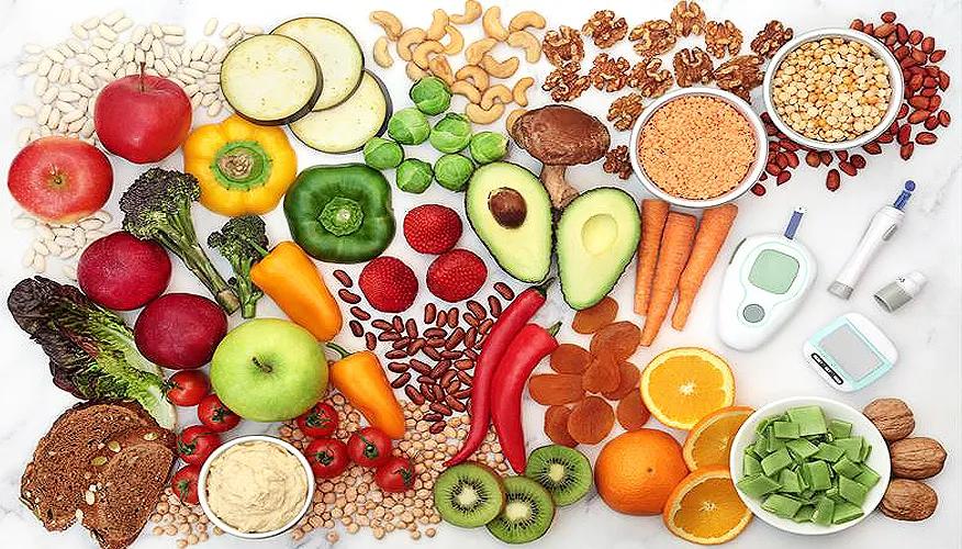 Assorted fresh fruits, vegetables, whole grains, nuts, and legumes with diabetes blood glucose monitors