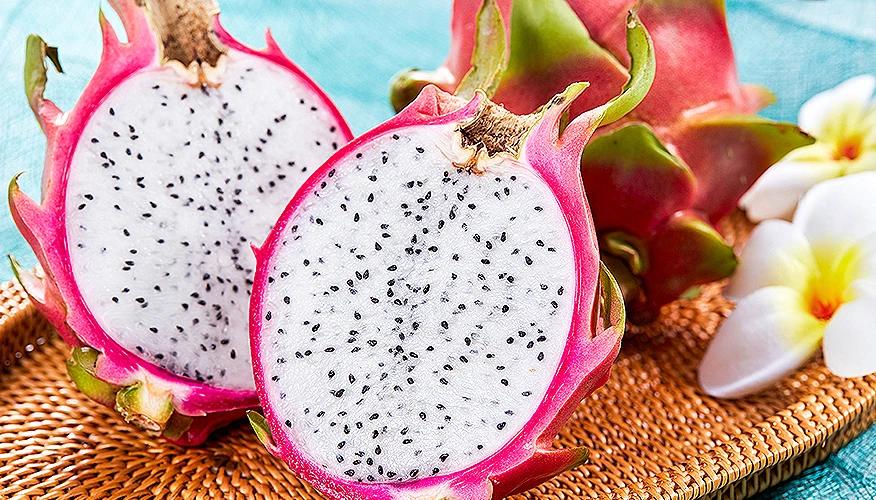 sliced dragon fruit showing white flesh and black seeds, good for skin